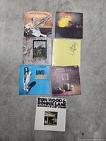 Top-down photo of the seven vintage vinyl record albums arranged on the floor.