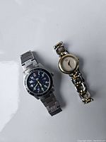 Two wristwatches placed on a white background showing both the Swiss Army and Esquire watches side by side.