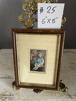 Full view of the framed miniature art piece showing the art and frame including a label '#25 6"x8"'