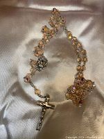 Full view of the Swarovski prayer beads rosary laid out showing the length, bead details, centerpiece, and crucifix