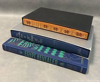 Three hardcover books stacked: At the Court of the Borgia Johann Burchard, The Story of Art, Egypt Revealed