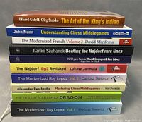 Stack of 10 chess related books showing titles and authors on spine and covers.