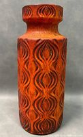 Front view showing embossed geometric onion pattern in burnt orange on the vase