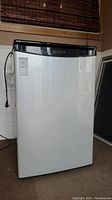 Front view of the Danby Designer bar fridge showing white door panel, black top and sides.