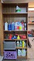 Front view showing the shelf loaded with various containers and household items.