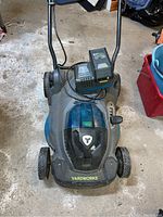 Top view of Yardworks battery operated mower showing the blue battery compartment, wheels, and adjustable lever.