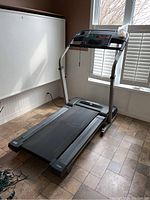 Full view of the Weslo Treadmill 330 model placed in a room with tiled floor and window in the background.