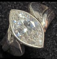 Close-up of the ring showcasing the marquise-cut clear stone and sterling silver band.