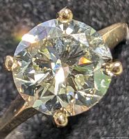 Close-up top view showing round brilliant diamond and prongs