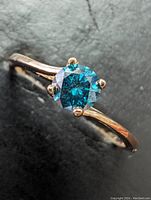 Ring top down view on black background showing diamond and band