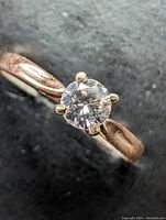Angled view of ring highlighting band detail and diamond