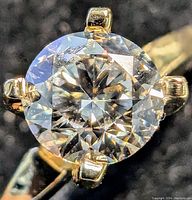 Close-up of round brilliant cut diamond in four-prong setting