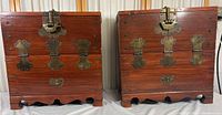 Front view of 2 wooden Korean chests with brass locks and hinges, showing identical design and condition.