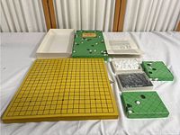 Full set including board, pieces, instruction manual, and packaging tray on table