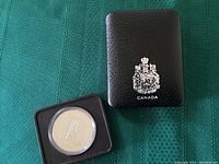 Photo of the black protective outer sleeve with the Canadian coat of arms and the word 'CANADA' on its face