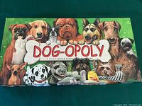 Box lid showing colorful dog breed illustration and Dog-opoly title