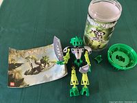 Complete set showing assembled Lewa Nuba figure alongside instruction manual, canister container, and shield.