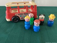 Photo showing the red and cream Fisher Price Mini Bus with 5 Little People figures arranged in front and on top, highlighting the bus and figure details.