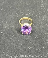 Ring top view on black background showing amethyst and setting