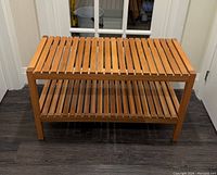 Wooden bench with slatted top and lower shelf, front and top views shown. Benches are rectangular with natural wood finish and sturdy legs.