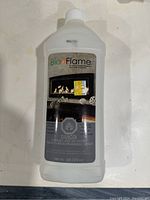 Single bottle of Bio Flame bio ethanol fuel showing label with fireplace image and text.