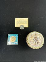 Top view of set showing commemorative Prince Charles and Lady Diana Spencer coin, Queen Elizabeth certificate and coin, and decorated stoneware keepsake box.