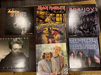 Photo showing all 7 LP albums including The Honeydrippers, Iron Maiden, Molly Hatchet, Simon and Garfunkel, Bon Jovi, Bryan Adams, and Deep Purple.