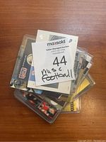 Stack of football cards in protective plastic sleeves forming the lot.