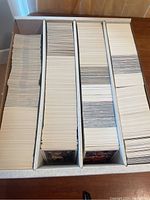 Long cardboard box holding thousands of basketball trading cards arranged vertically