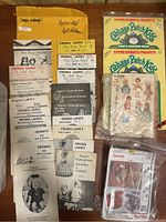 Various vintage doll patterns by Virginia Lakin, Cabbage Patch Kids envelopes, and other assorted pattern booklets and instructions laid out on a surface.