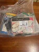 Plastic bag with various packaged Vogart embroidery transfers stacked inside.