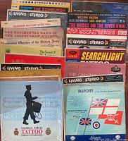 Collection of various vintage military music vinyl records showing album covers with band titles and military images