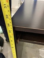 Photo showing the height measurement of the desk approximately 29 inches from floor to tabletop.