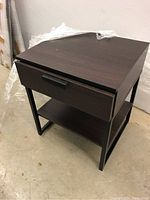 Photo of the dark wood end table showing the drawer and lower shelf with black legs