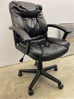 Black leather office chair with cushioned seat, back, and armrests on a five-wheel black base.