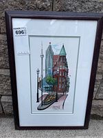 Framed print showing colorful Toronto cityscape with CN Tower and historic architecture.