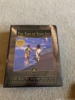 Closed outer case of Anthony Robbins The Time of Your Life Course showing beach running image and course title.