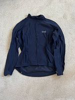 Front view of black Gore Bike Wear women's thermal long sleeve cycling jersey with full zipper and brand logo on chest.