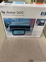 Front view of the original retail box of the HP Deskjet 5650 printer showing an image of the printer and product branding.