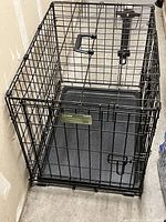 Full view of small wire dog crate with carry handle, single door, and removable plastic tray.