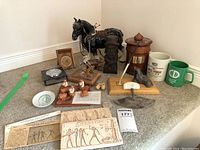 Full lot including pharaonic plaques, figurines, mugs, and carved wood pieces.