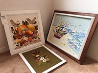 Three embroidered artworks displayed together, mushrooms, cattails, beach scene