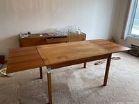 Front view of table fully extended with both leaves attached