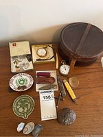 Full lot view showing all items including Victorian collar box, pocket watches, stopwatch, knives, cufflinks, cross pendant, patches, and stones.