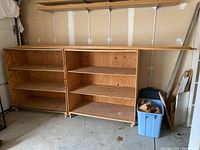 Photo showing two plywood shelving units side by side in a garage setting.