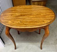 Top view of oval-shaped vintage wood coffee table showing smooth polished surface and wood grain