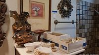 View of decorative shells, picture, soap dish, and ceramic items arranged on countertop