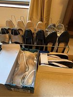 Eight pairs of women's shoes in various colors and styles organized in a wire shoe holder