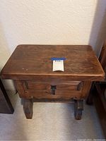 Front view of the dark walnut small side table showing drawer and table top