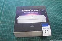Box of Apple Time Capsule 2TB with 802.11n Wi-Fi router displayed on green cutting mat